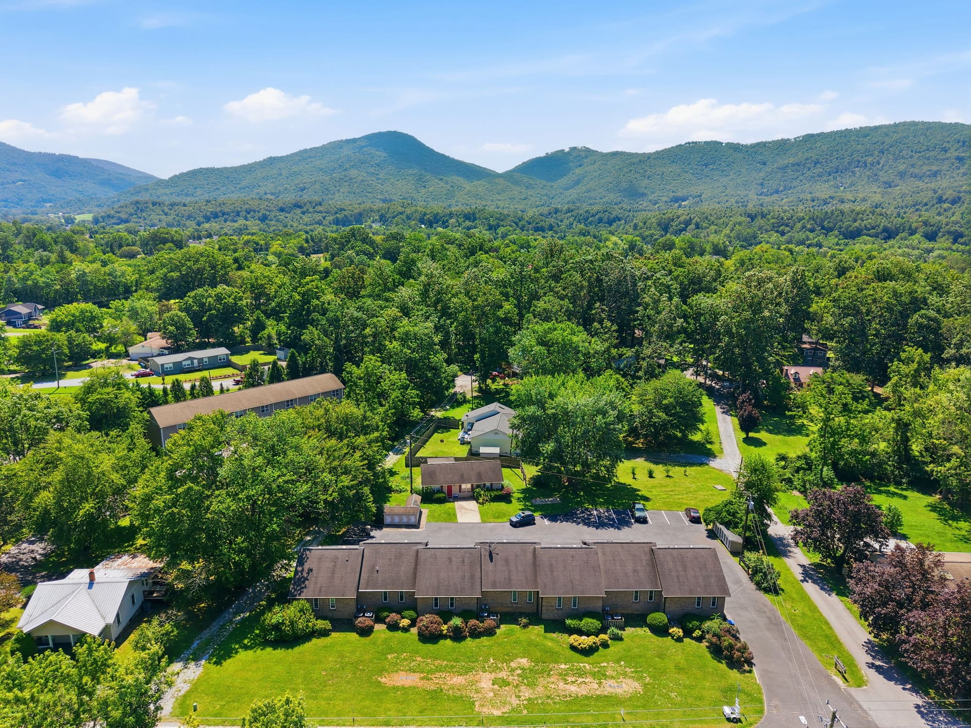 Aerial view of the Country Gardens building in high summer, with the Blue Ridge Mountains behind